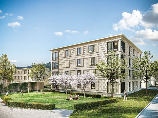 Der Neugrüen-Platz bringt mit einem Café, Bäumen und Sitzbänken urbanes Flair in die Siedlung.
